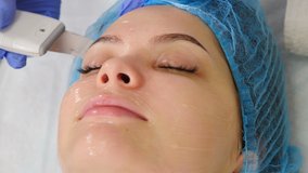 Beauty clinic and machine cosmetology. Professional cosmetologist working with ultrasonic facial machine while doing cleansing procedure. Non-surgical face lifting. dermatologist doctor. 4 k video