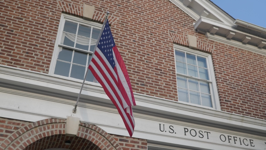America flag hanging over post office entrance