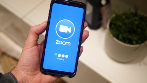 Zoom app on a mobile phone loading on the screen. Popular video conference app helping people connect during Covid-19 MONTREAL CANADA NOVEMBER 2020