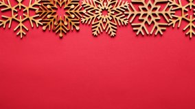 Handmade wooden snowflakes in flat lay video clip with empty space for invitation text.Christmas party decoration footage shot in closeup 4K ultra hd resolution