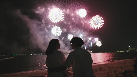A Lovers couple background celebration firework at night, Valentine Day concept, Couple watching fireworks at wedding