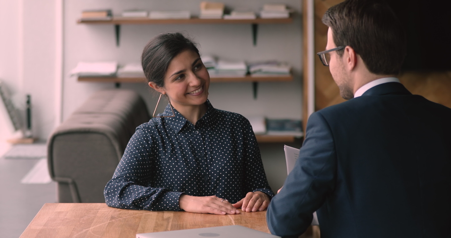 Indian ethnicity 25s confident female applicant passing job interview finish formal appointment shaking hands with male employer. Successful business meeting, making deal, hr, company staffing concept Royalty-Free Stock Footage #1063137853