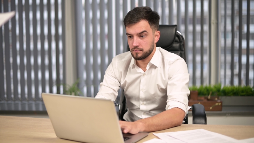 Colleagues and executives overwhelmed the young male head of the office with work. Too much work for one person, overload | Shutterstock HD Video #1063139779