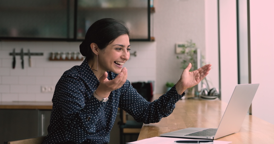 Indian woman sit in office or home kitchen use laptop check email read fantastic news. Offer sale good price, career promotion salary growth, on-line auction winner celebrate monetary victory concept | Shutterstock HD Video #1063141954