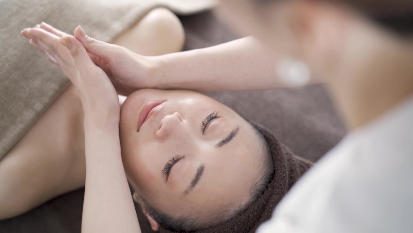 Japanese woman receiving a facial massage at an aesthetic salon Royalty-Free Stock Footage #1063146361