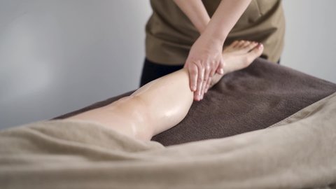 Japanese woman receiving a foot massage at an aesthetic salon