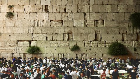 Religious ritual at holiest site israel. Jew pray for Yom Kippur and Rosh Hashanah blessing holidays. Crowd of Jewish people praying at the holy western wall big rock in the old city of Jerusalem