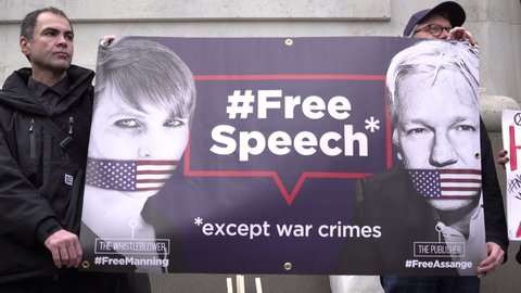 London , United Kingdom (UK) - 02 22 2020: Protestors hold a banner of Julian Assange and Chelsea Manning