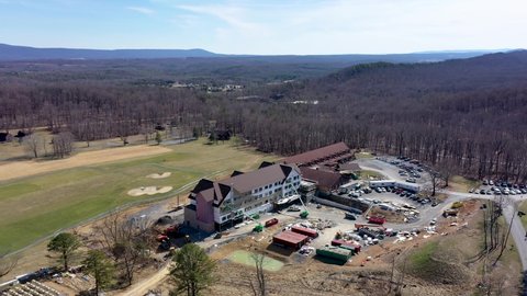 Aerial ascent with camera tilt down showing Cacapon State Park lodge expansion construction project in the hills of West Virginia.