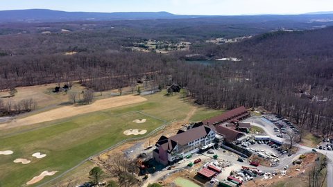 Aerial orbit to the right showing Cacapon State Park lodge construction and its setting on the golf course and in the remote mountains of West Virginia.
