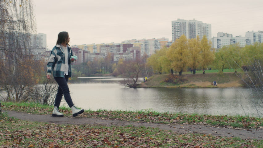 The girl is going in the park close to the lake.Red Helium 8K
