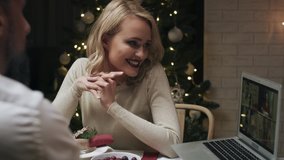 Video of happy couple having video meeting during Christmas dinner