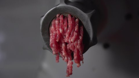 Production of minced meat from fresh meat with an electric meat grinder at home close-up