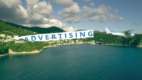 Flying plane with banner with ADVERTISING text on summer background