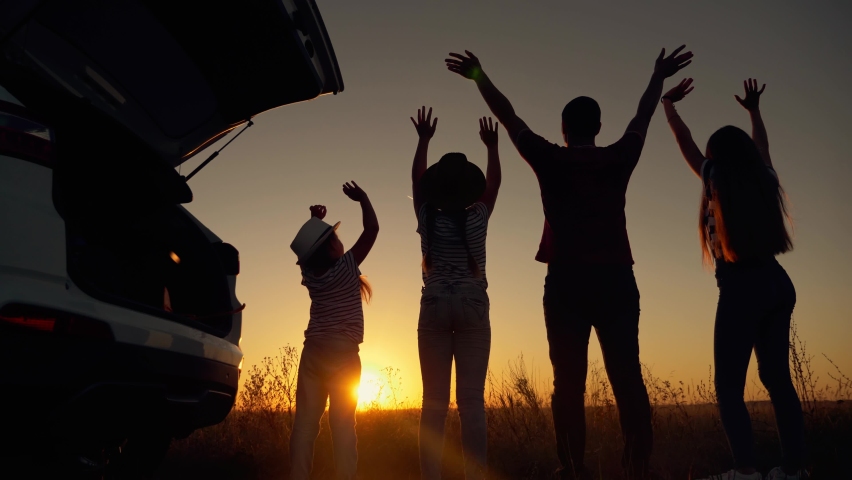 Beautiful family silhouette. Many people hands up together. People lifestyle concept of family travel by car. Happy family resting together at sunset. | Shutterstock HD Video #1063160485