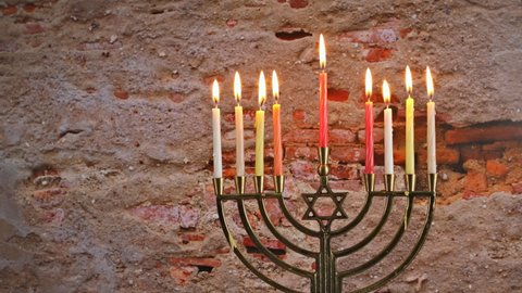 Hanukkah candles celebrating menorah with all candles burning.