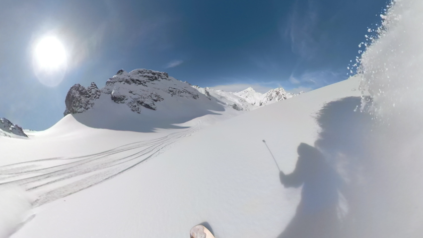 POV: Shredding virgin powder snow while riding off trail in the scenic white Canadian Rockies. Cool first person shot of snowboard touring in the Rocky Mountains on a picturesque sunny winter day. | Shutterstock HD Video #1063162336