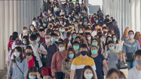 Bangkok, Thailand-27 November, 2020: crowds of Asian people wearing face protection walking at work in early morning,Concept of coronavirus quarantine, COVID-19, new normal concept 