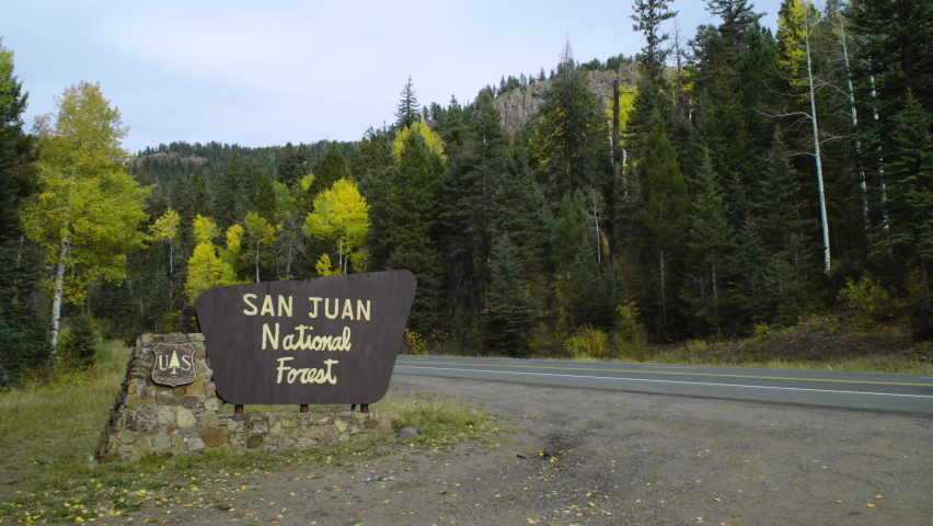 San Juan National Forest area sign by the road between trees. In Pagosa Springs, Colorado, U.S.