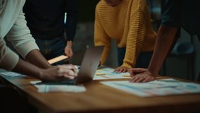 Close Up of Diverse Multiethnic Team Having Conversation in Meeting Room in a Creative Office. Colleagues Lean On a Conference Table, Look at Laptop Computer and Make Notes with Pencils on Notebooks. - Powered by Shutterstock - Get 15% off with code: PIKWIZARD15