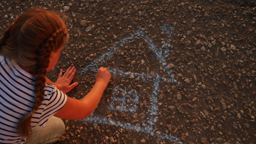 Child kid draw a house on the asphalt with chalk . childhood mortgage dream kid concept. little girl playing draws with chalk big house. concept loan mortgage for a dream residential building home | Shutterstock HD Video #1063173442