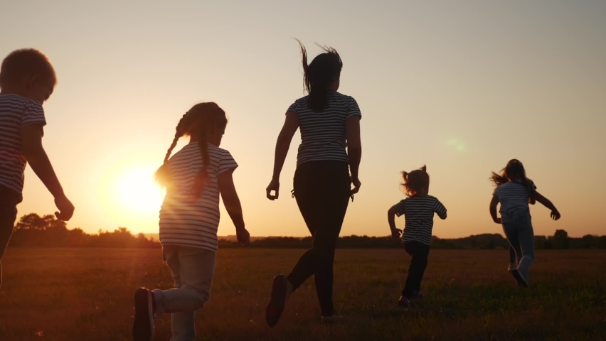 Children happy family kid together run in the park at sunset silhouette. people in the park concept. mom daughter and son joyful run. happy family and little baby fun child summer kid dream concept | Shutterstock HD Video #1063173574