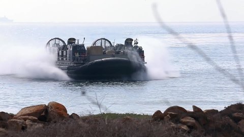 CIRCA 2020 U.S. Marine Air Cushioned Landing Craft tranports weapons from ship to shore during a field exercise, California.