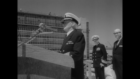 CIRCA 1963 - Admiral Nimitz and Secretary Korth of the US Navy oversee the commissioning ceremony for the USS Halsey, a guided missile frigate.