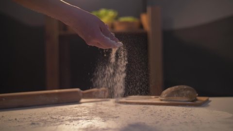homemade pastry flour and dough. lower gluten pastry flour. hands of a person preparing dough for baking. flour falling slow motion. cooking beautiful footage