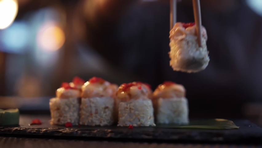 Sticks Take Sushi in Restaurant Stock Footage Video (100% Royalty-free