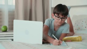Home Isolation, Online Learning, Remote Work, New Education. A child uses a laptop during online learning