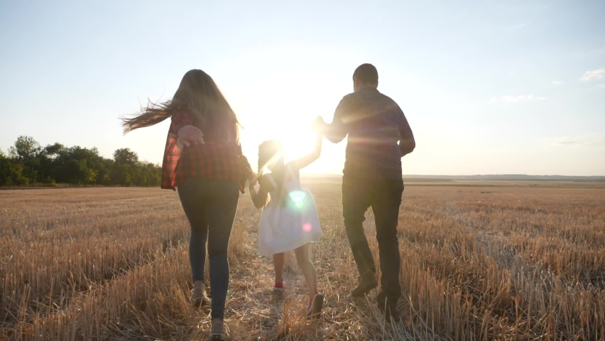 happy family run in field throw up their daughter. kid dream concept. daughter and parents run across wheat field near park. happy family dream of happiness. kid child and parents run fun in the park Royalty-Free Stock Footage #1063189303