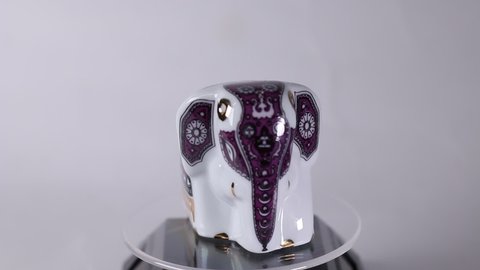 Ceramic antique elephant figurine rotating on a spinning platform 
