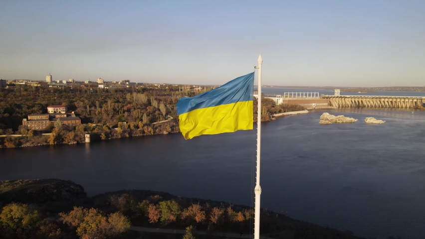 Zaporozhye, Ukraine, dam, aerial view of the Dnieper hydroelectric station. Flag of Ukraine, the flag is evolving. | Shutterstock HD Video #1063192180