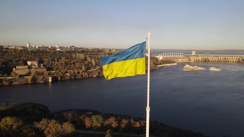 Zaporozhye, Ukraine, dam, aerial view of the Dnieper hydroelectric station. Flag of Ukraine, the flag is evolving.