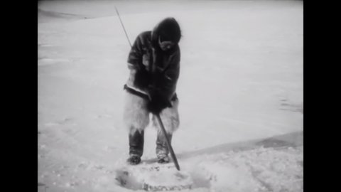 CIRCA 1922 - In this silent documentary, an Inuit man carves a final block of ice for his igloo.