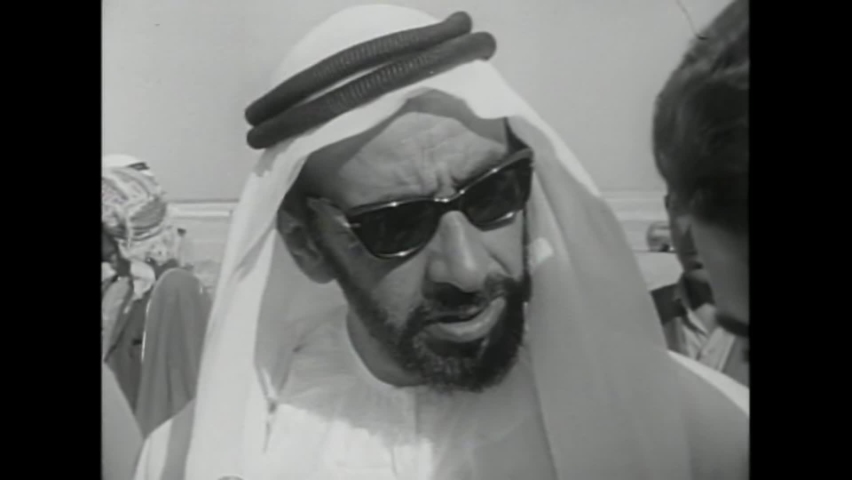 CIRCA 1960s - Sheikh Zayed visits construction sites in Abu Dhabi, and consults with American businessmen through a translator in 1967.