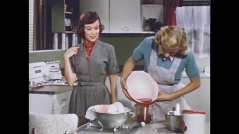 CIRCA 1950s - As a girl makes jam for a home economics assignment, she explains to her sister why it's better practice for becoming a housewife.