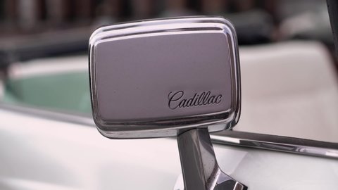 SAINT-PETERSBURG, RUSSIA - JULY 13, 2020: Cadillac white old retro car logo brand rear mirror