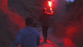 The video shot of running man with a fire stick in his hands