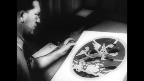 CIRCA 1940s - Walt Disney supervises the illustration of wartime insignias, including one of Mickey Mouse.