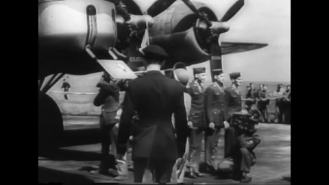 CIRCA 1940s - King George VI and Queen Elizabeth visit British and American air bases in 1944; the Queen christens a bomber.