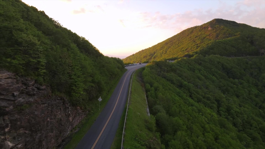 ASHEVILLE, NORTH CAROLINA - CIRCA 2020 - Aerial over the Blue Ridge parkway and mountains at sunset near Asheville, North Carolina.