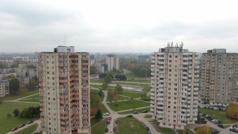 Done is flying in between two tall Soviet (USSR) style block apartment buildings in the Chechnya square (Čečėnijos aikštė) in Kaunas, Kalniečiai district, Lithuania