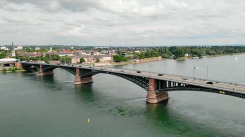 Aerial view towards traffic on a bridge, sunny day, Rein river, Mainz, Germany - dolly, drone shot