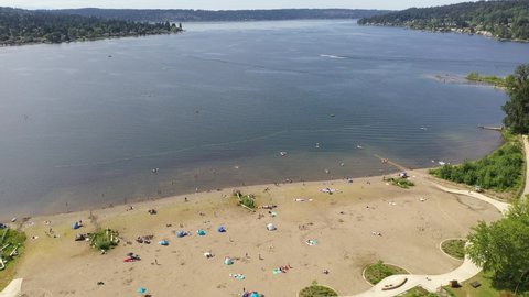 Aerial  drone pan footage of Lake Sammamish State Park, Issaquah, Sunset Beach, Tibbets Beach, Newport, Montreux, the I-90 highway, Lake Sammamish and surrounding suburbs in King County, Washington