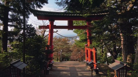 fly through torii gate to reveal the city around chureito pagoda