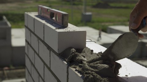 Construction.Construction of a multi-storey building.The Builder lays bricks.Close up