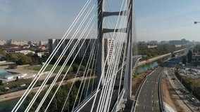 Aerial footage of a suspended bridge in Bucharest on a sunny day