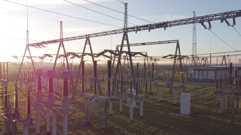 Transformer : The equipment used to raise or lower voltage, high voltage power station. Top view from flying drone. Wide angle, high voltage substation with tall pylons and voltage distribution cables